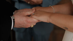 Close-up of couple holding hands at Chapel Dulcinea